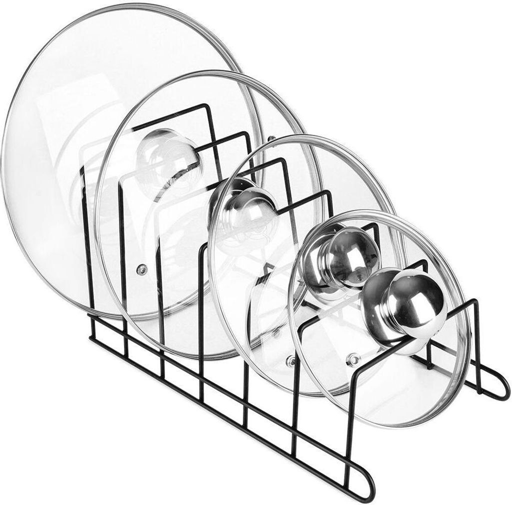 A black metal pot lid organizer holding four glass pot lids of varying sizes.