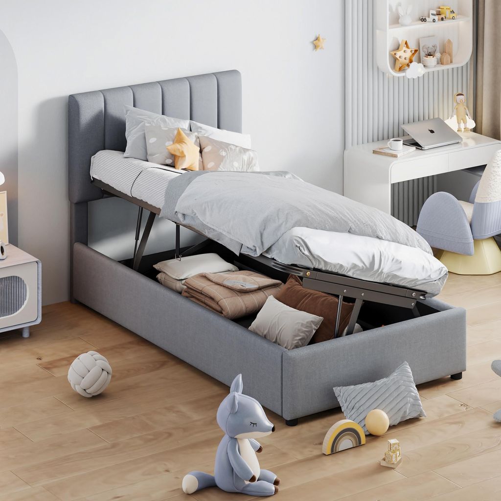 A child's bedroom with a bed that has storage underneath, a desk with a laptop, and toys on the floor.