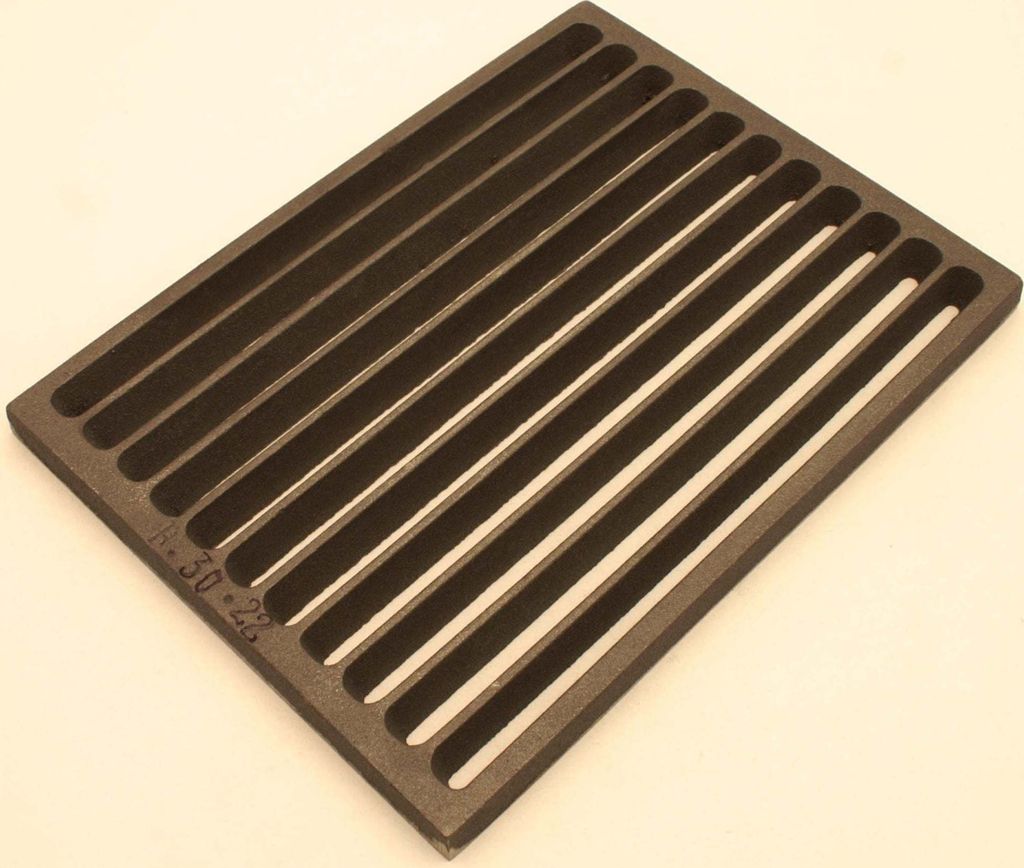 A dark gray cast iron grate with parallel slats is shown from a slightly elevated angle against a light gray background.
