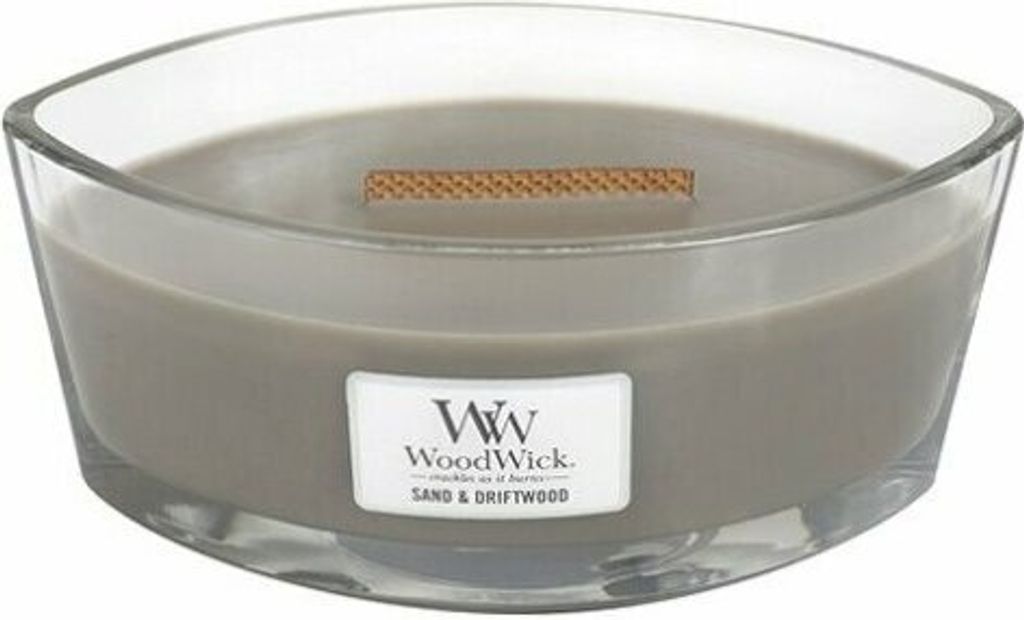 A close-up studio shot of a WoodWick Sand & Driftwood candle in a clear glass container.