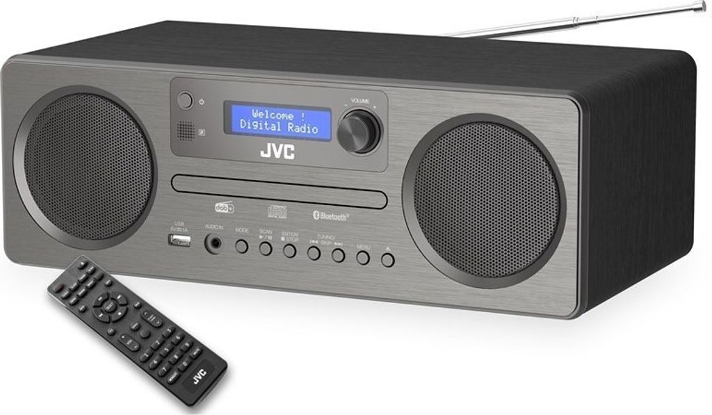 A JVC mini-tower stereo system with a remote control in front of it, set against a white background.