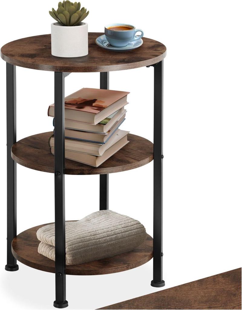 A three-tiered round side table with a plant, books, and a cup of coffee.