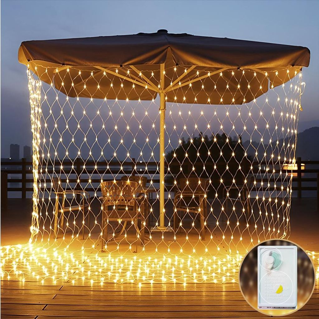 Outdoor patio area at dusk with a large umbrella decorated with a net of warm white fairy lights.