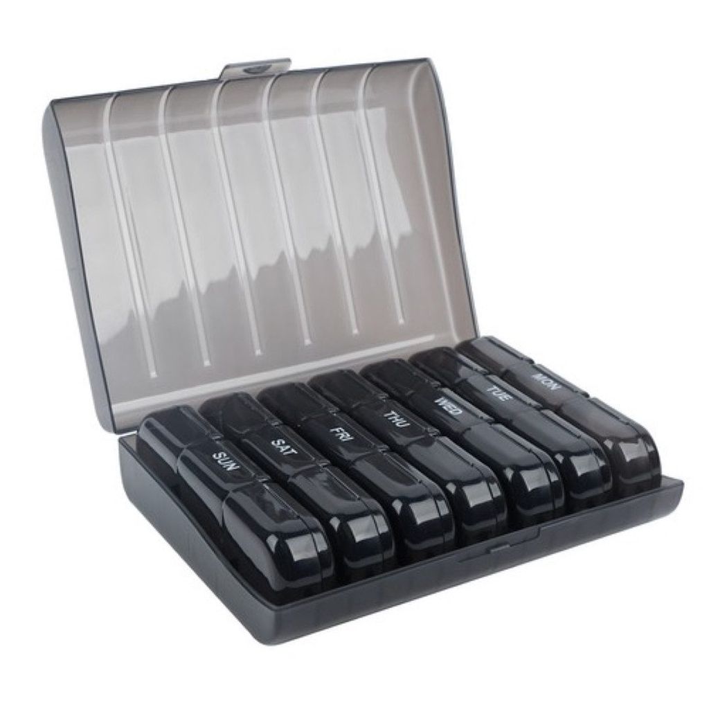 An open pill organizer with seven individual compartments, each labeled with a day of the week.