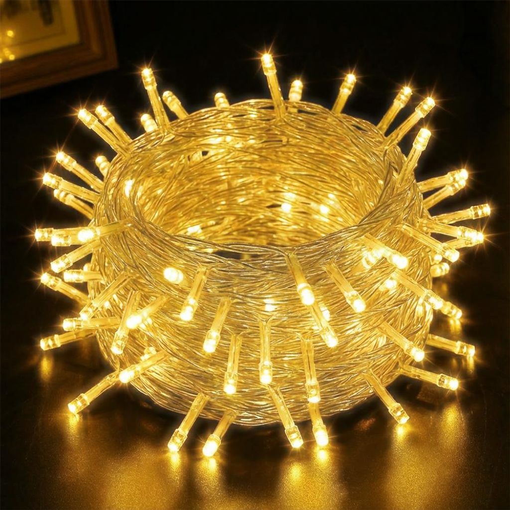 A close-up shot of a coiled string of warm white LED lights.