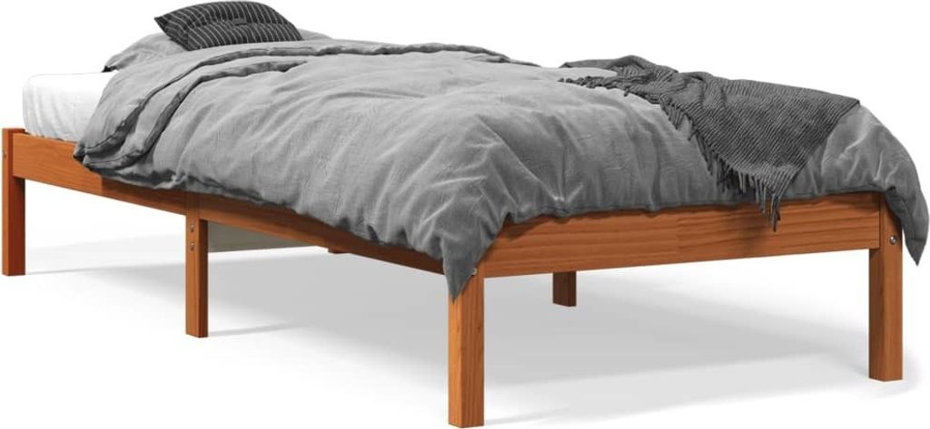 A wooden bed frame with bedding and a blanket.