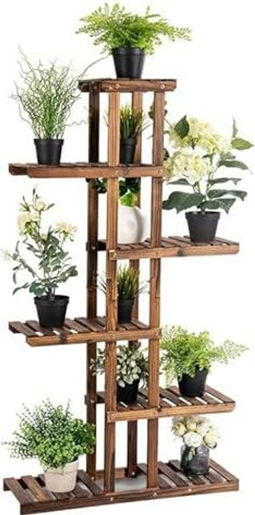 A multi-tiered wooden plant stand filled with various potted plants.