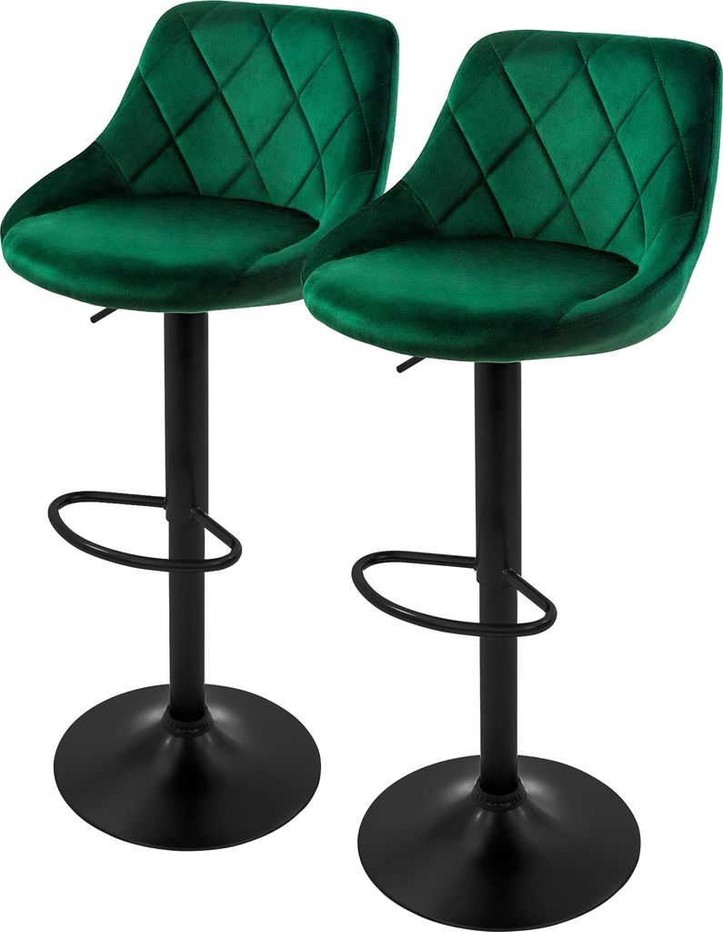 Two green velvet bar stools against a white background.