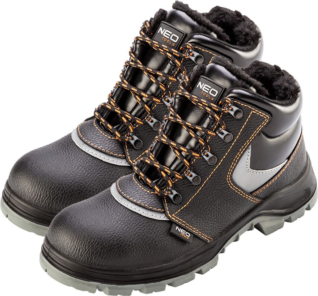 A pair of black winter work boots with orange laces and gray accents, shown from a slightly elevated side angle against a white background.