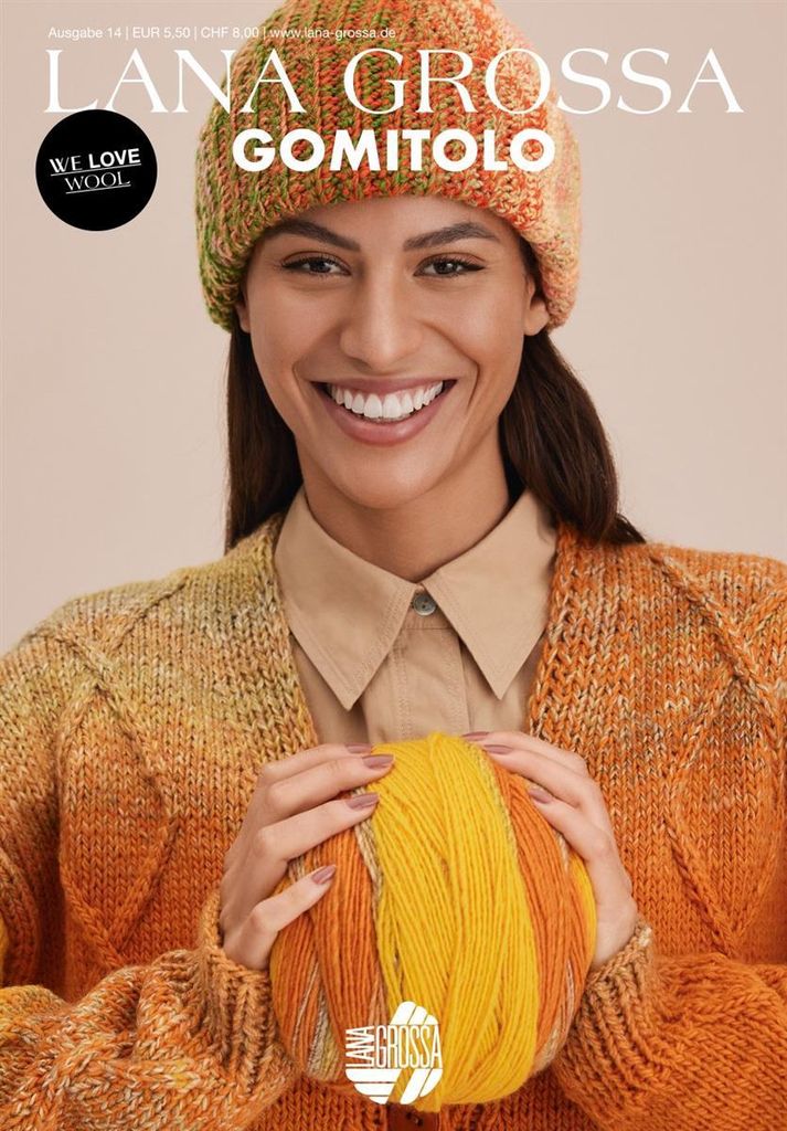 A woman is holding a ball of yarn, wearing a knitted hat and cardigan.