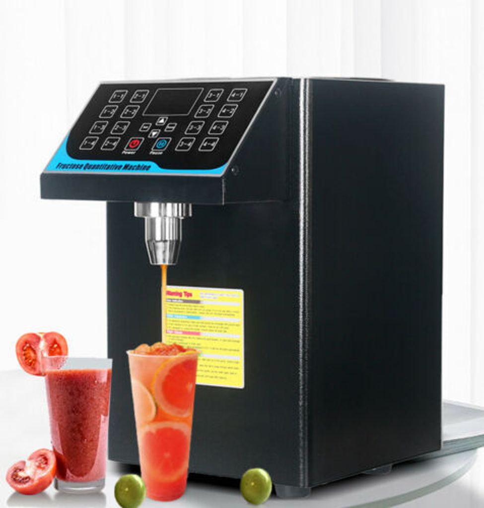 A black fructose quantitative machine is shown dispensing liquid into a glass, with two glasses of juice and some fruit in the foreground.