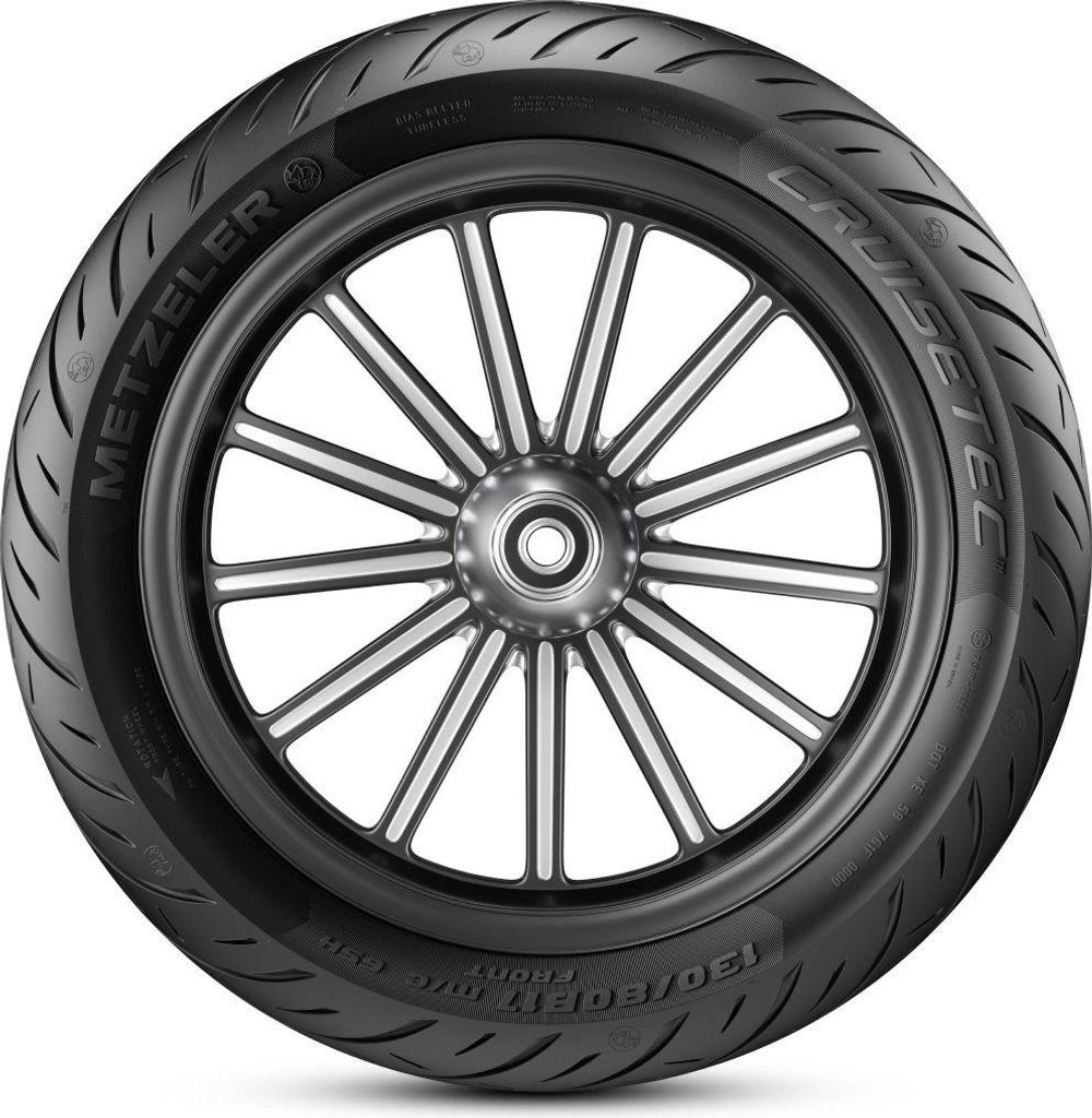 A close-up studio shot of a motorcycle tire mounted on a silver spoked wheel.