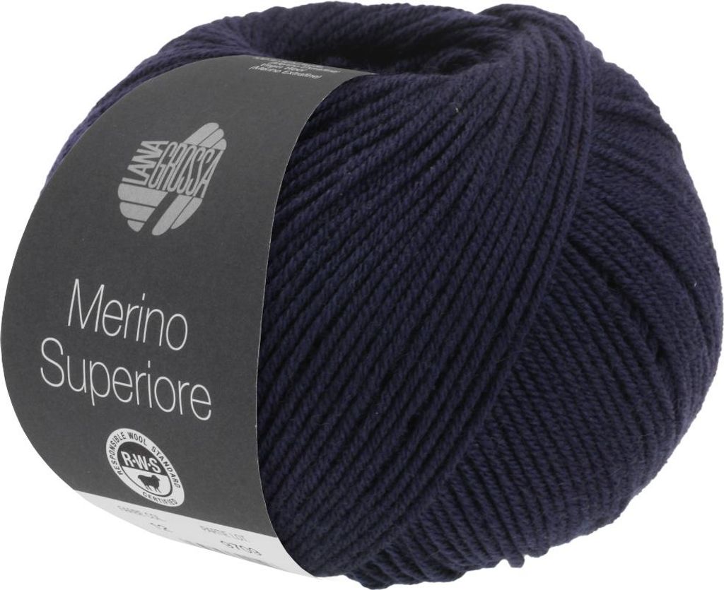 A ball of dark blue yarn with a label wrapped around it.