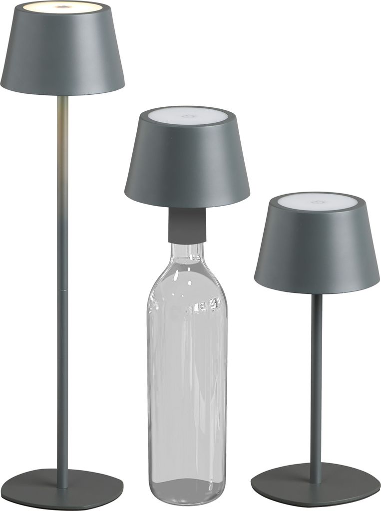 Three modern LED table lamps of varying heights, one of which is placed on a clear glass bottle.