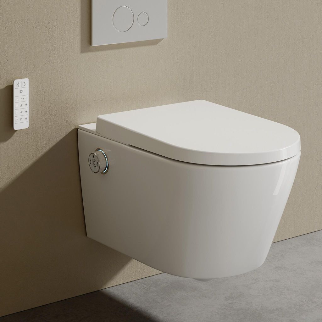 A wall-mounted toilet with a bidet function and a remote control on the wall.