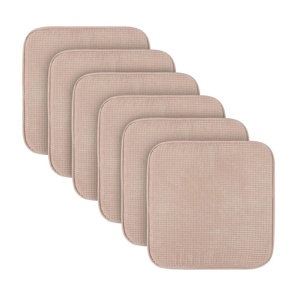A stack of beige seat cushions arranged diagonally.