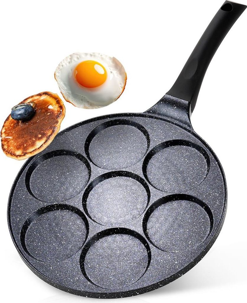 A multi-cup frying pan with a pancake and a fried egg on a white background.