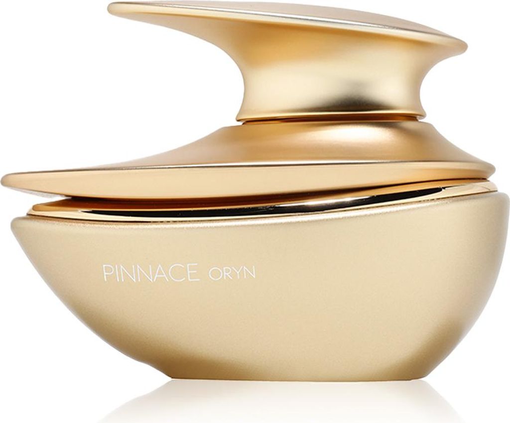 A product shot of a gold perfume bottle.