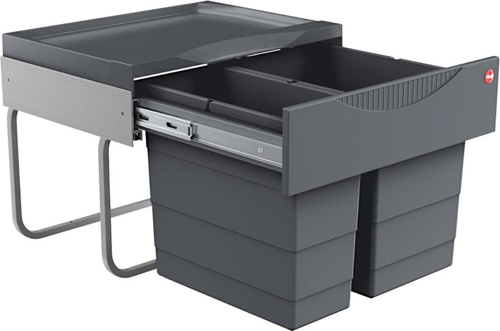 A dark gray kitchen waste bin system with two compartments, shown with one drawer pulled out.