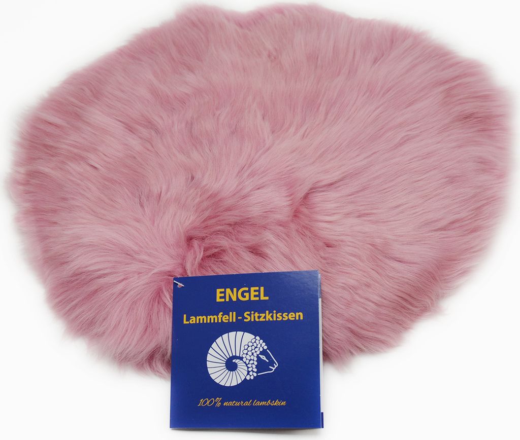 A pink sheepskin seat cushion with a blue product tag in front of it.