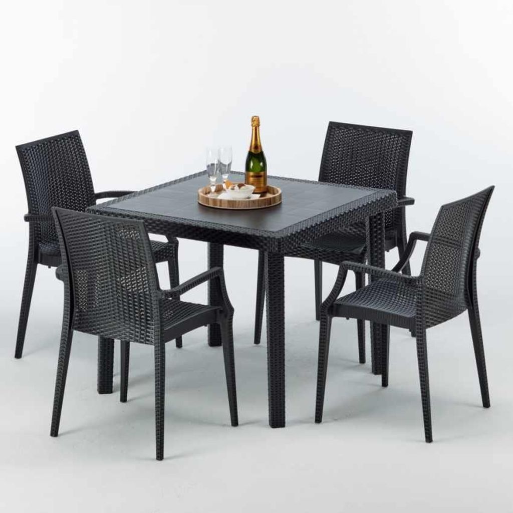 A black square table with four black chairs, set up for an outdoor dining scene.