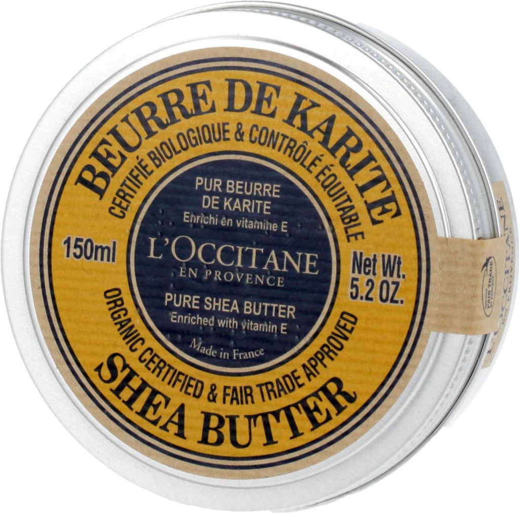 A close-up, top-down view of a round metal tin of L'Occitane Shea Butter.