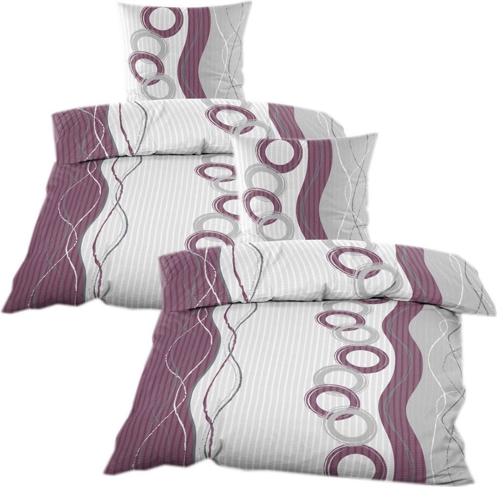 A stack of bedding with a purple and gray circular pattern on a white background.