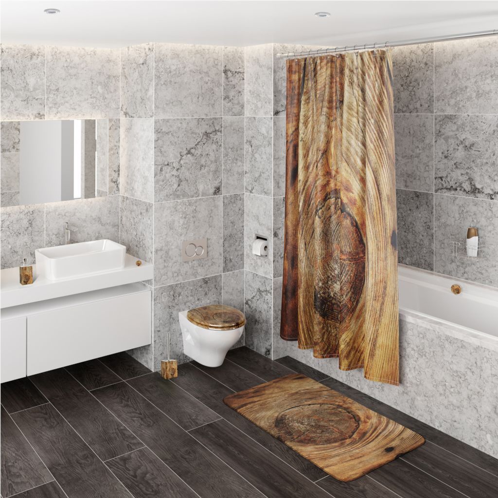 A modern bathroom with marble-tiled walls, a wooden-patterned shower curtain and bath mat, a white sink, and a toilet.