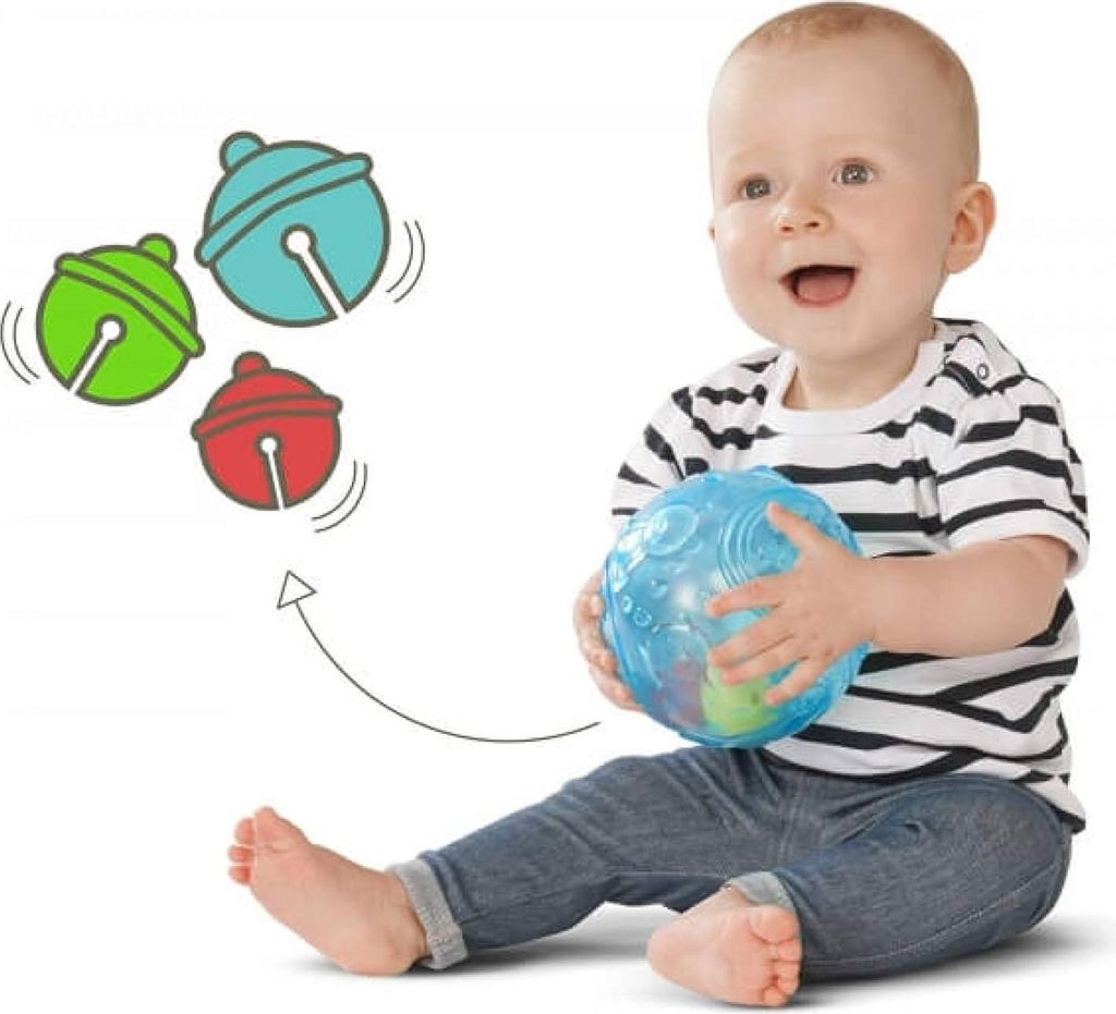 A baby sitting on the floor and holding a blue ball, with cartoon bells floating in the air.