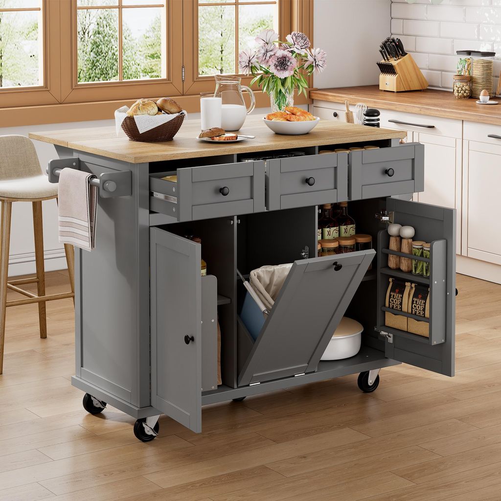 A gray kitchen island with a wooden countertop is shown in a kitchen setting, with a stool and kitchen cabinets in the background.
