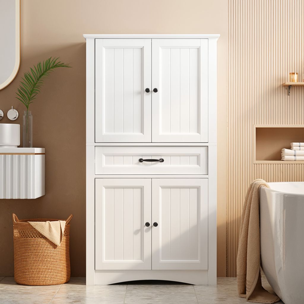 A white bathroom cabinet is shown in a bathroom setting, next to a bathtub and a laundry basket.