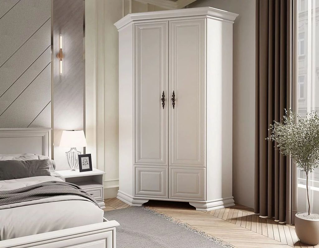 A white corner wardrobe in a bedroom setting.