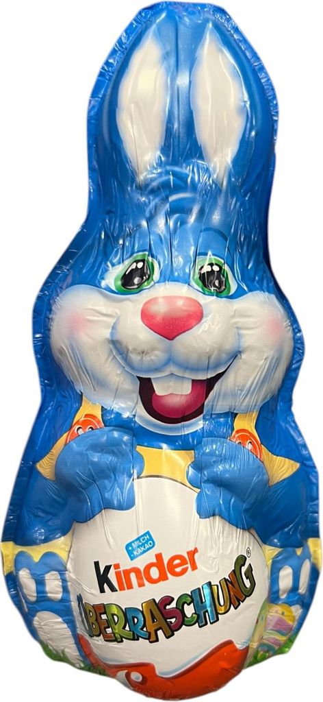 A blue chocolate Easter bunny wrapped in foil, holding a Kinder Surprise egg.