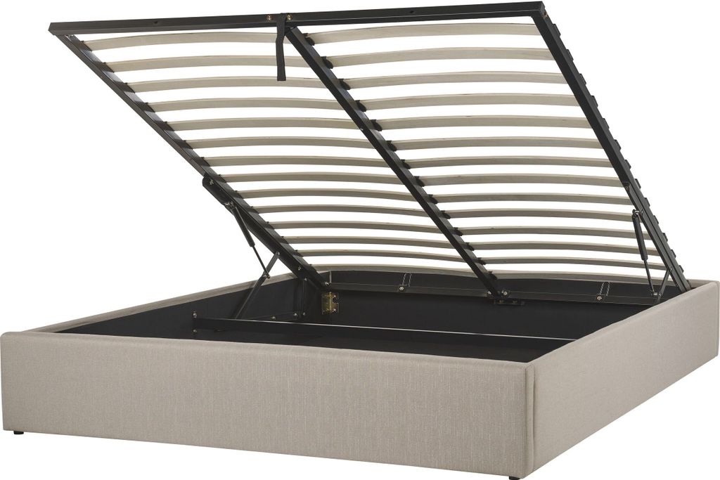 A bed frame with the mattress support slats lifted open, revealing the storage space underneath.