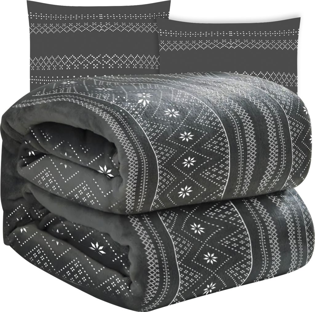 A folded blanket and two pillowcases with a geometric pattern.