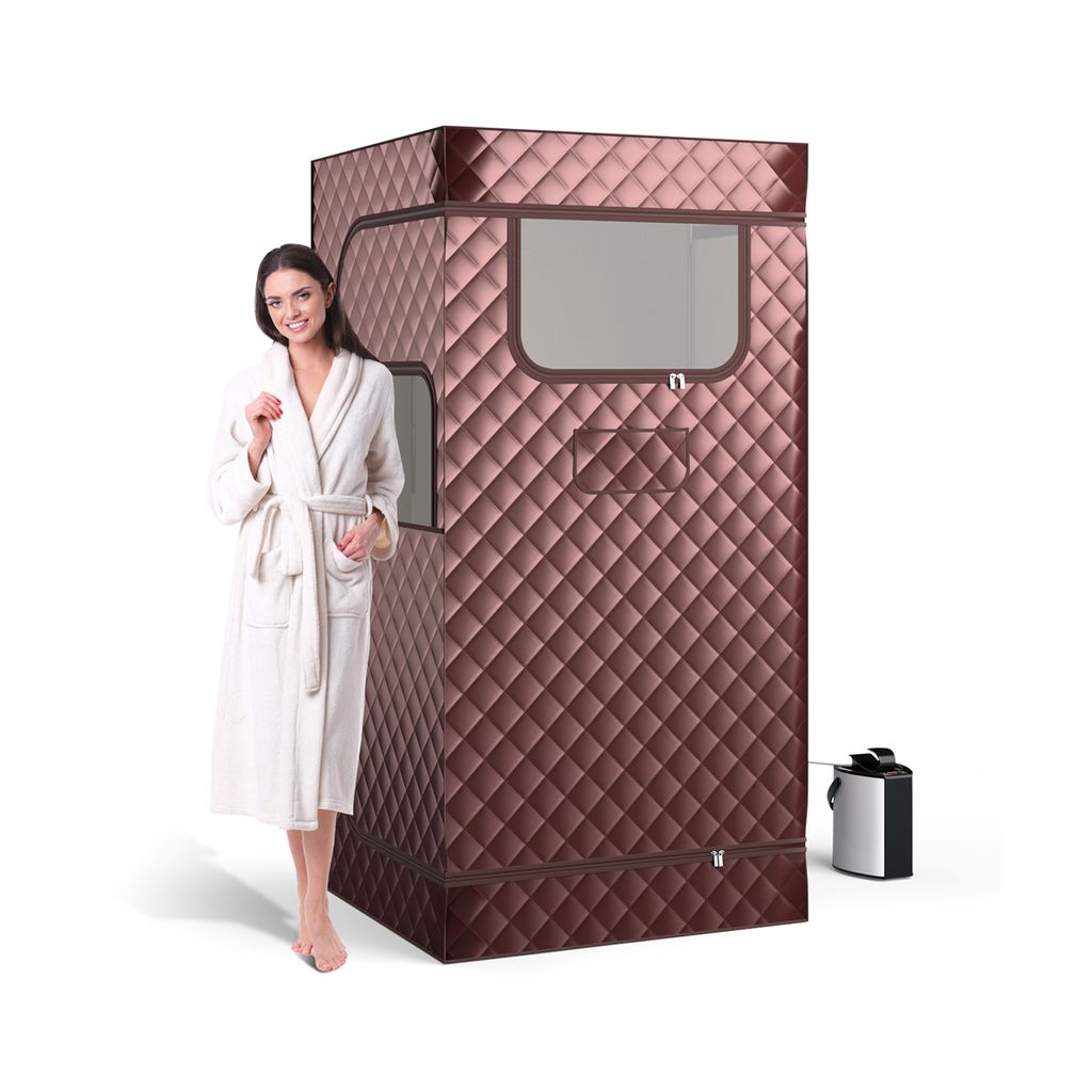 A woman in a bathrobe stands next to a portable steam sauna.