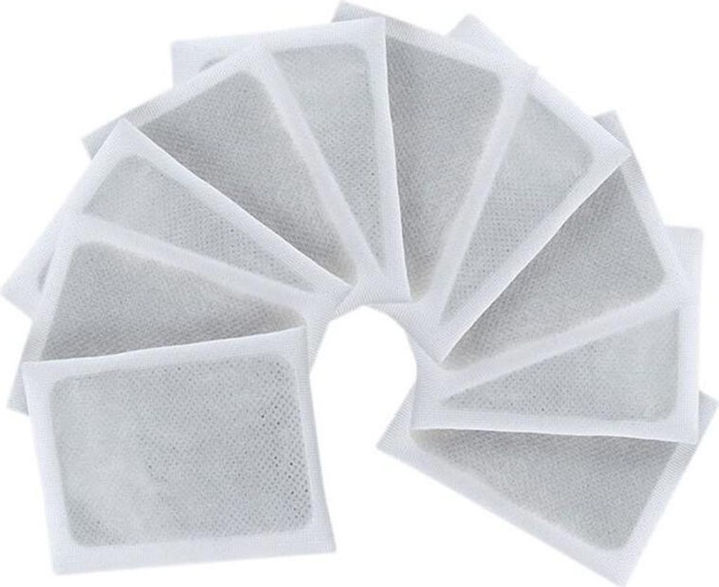 A fan arrangement of multiple white detox foot pads with gray filling.