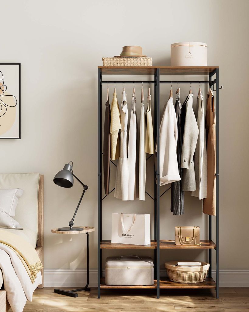 A bedroom scene with a clothing rack and bedside table.