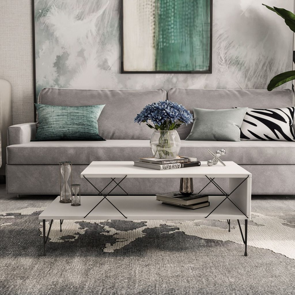 A modern living room scene with a couch, coffee table, and artwork.