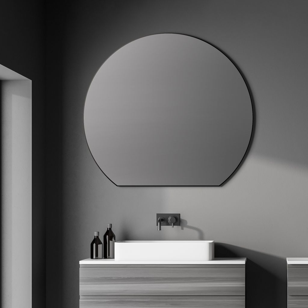 A modern bathroom vanity with a rectangular sink and a large round mirror above it.