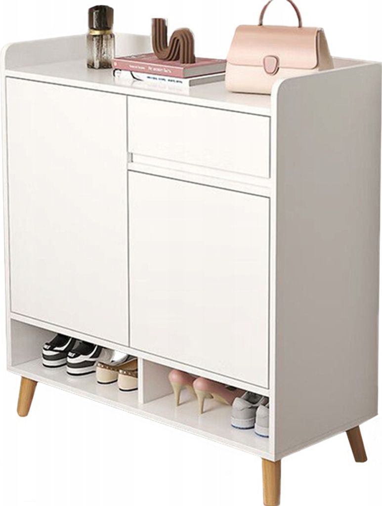 A white cabinet with a drawer and doors, used as a shoe organizer. Decorative items and a handbag are on top.