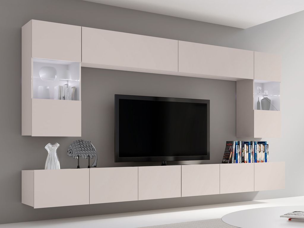 A modern living room wall unit with a TV and integrated shelving, illuminated by LED lights.