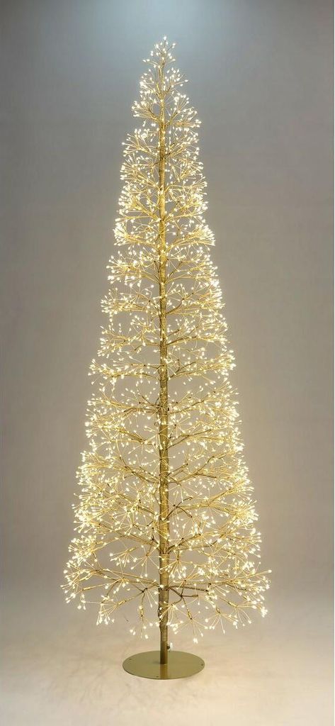 A tall, slender Christmas tree decorated with many small, bright white lights, standing on a circular gold base.