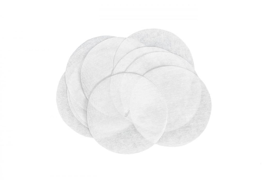 A pile of round, white, fabric-like pads.