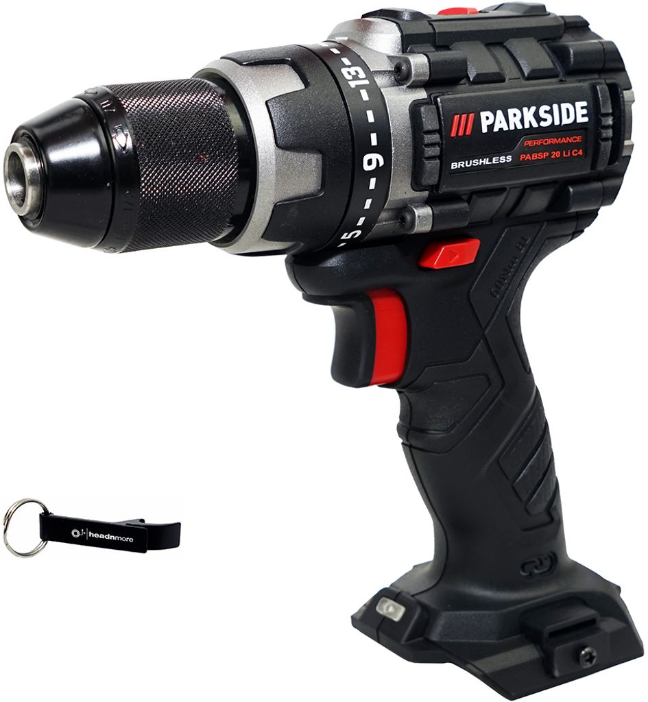 A black and gray cordless drill with a red trigger and accents, shown on a white background. A black keychain with a logo is placed to the left of the drill.