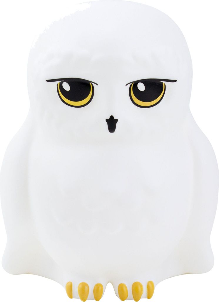 A white owl figurine with yellow eyes and feet against a white background.