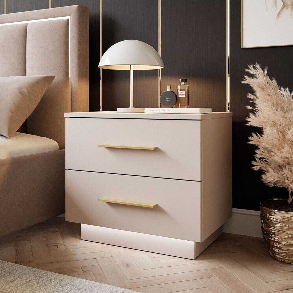A bedroom scene featuring a nightstand next to a bed.