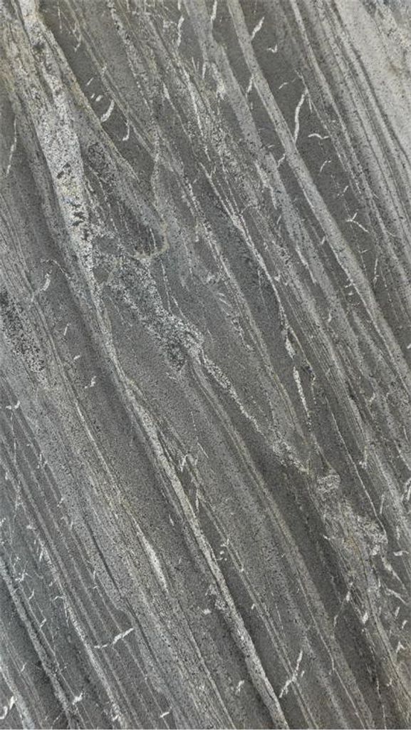 A close-up view of a stone veneer with a dark gray base and lighter gray and white veining.