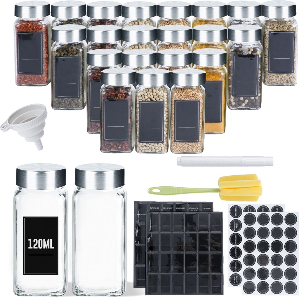 A collection of spice jars and accessories laid out on a white background.