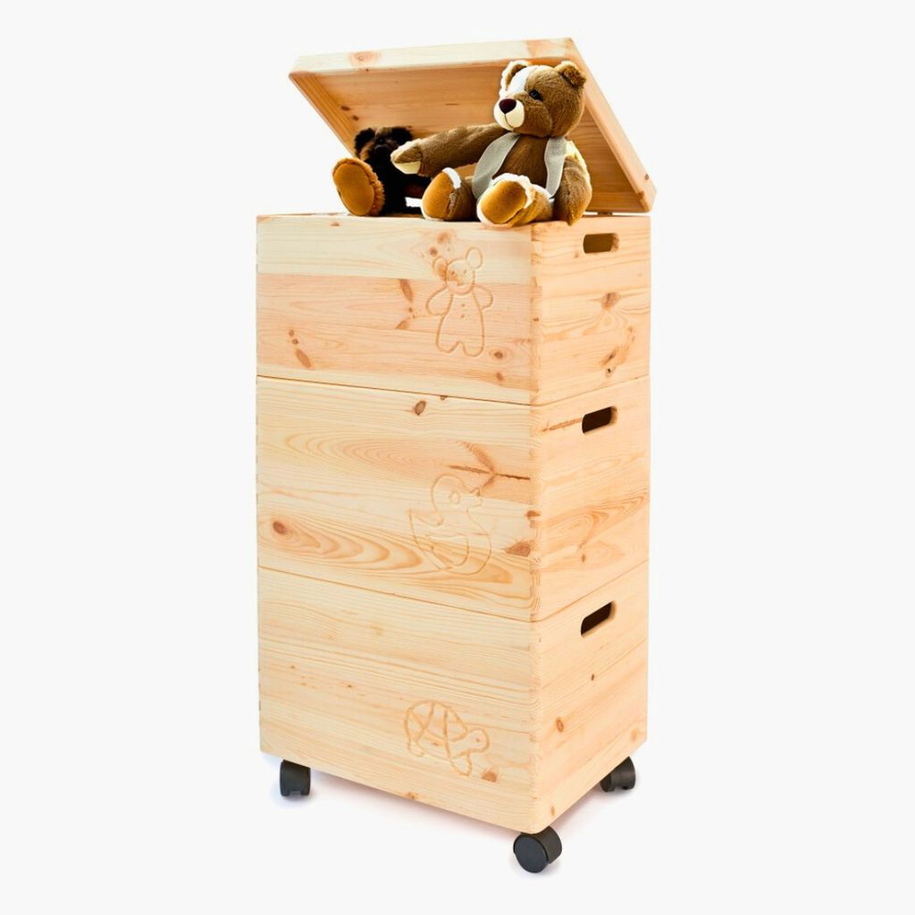 A stack of three wooden storage boxes with lids and wheels, with two teddy bears on top.